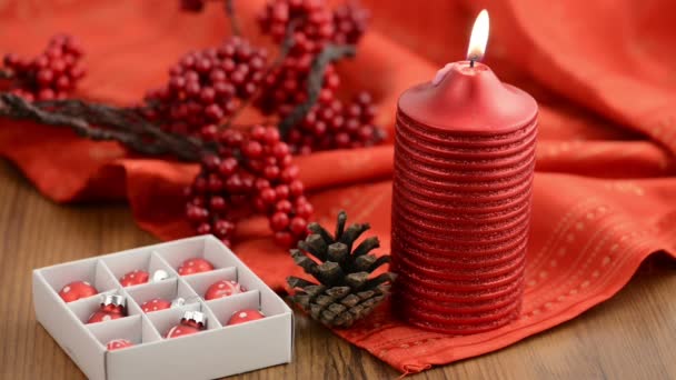 Star-shaped candle is lit. Besides Christmas tree balls. — Stock Video