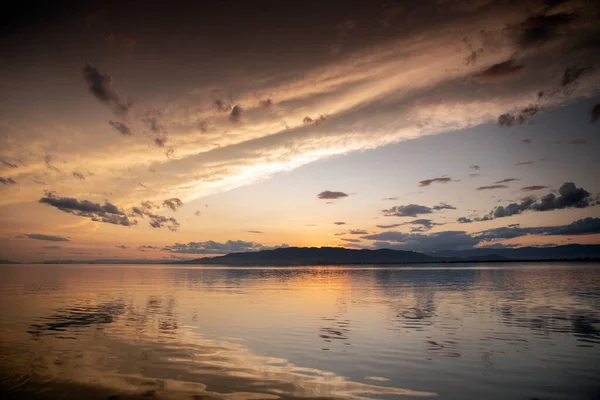 A sunset over water with clouds — Stock Photo, Image