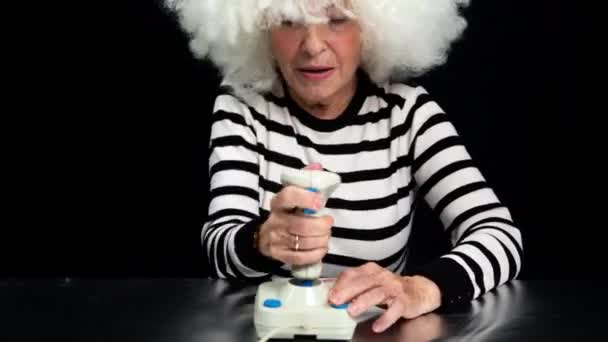 Gaming granny using joystick — Stock Video