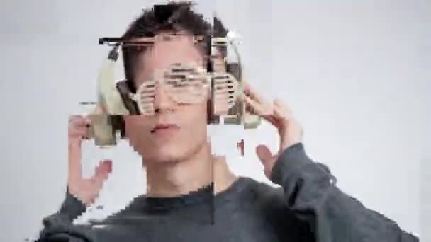 Mladý muž ve sluchátkách a přikyvování — Stock video