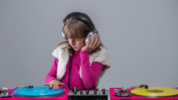 Girl with headphones round neck playing records — Stock Video