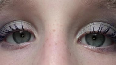 Genç kız kameraya bakıyor.