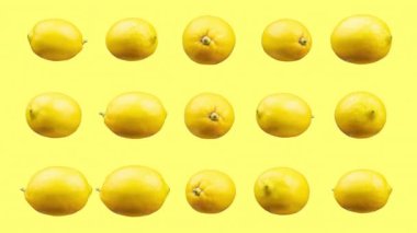 Sarı arkaplana karşı sıralanmış limonlar