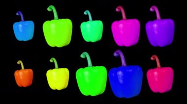 Siyah arka planda dönen renkli biberler