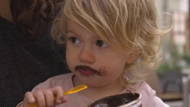 Baby girl eating chocolate icecream — Stock Video
