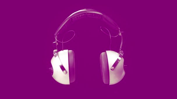 Vintage headphones against pink background — Stock Video