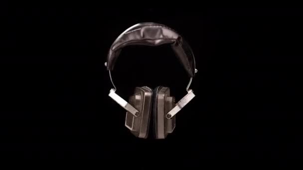 Vintage headphones against black background — Stock Video