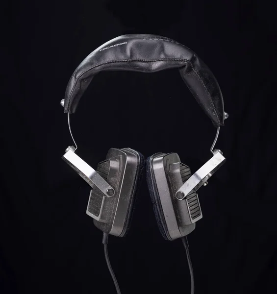 Vintage headphones against black background — Stock Photo, Image