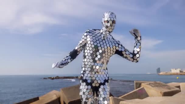 바다 옆에서 춤을 추는 반짝이는 디스코 복을 입은 남자 — 비디오