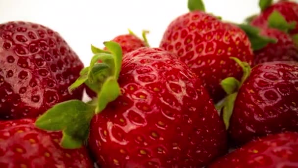 Macro shot of strawberries on white — Stock Video