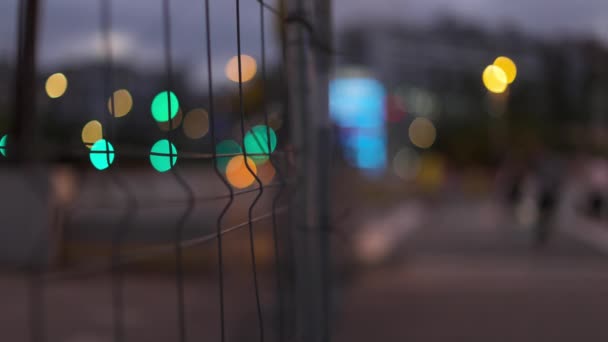 Close up of fence with city lights — Vídeo de Stock