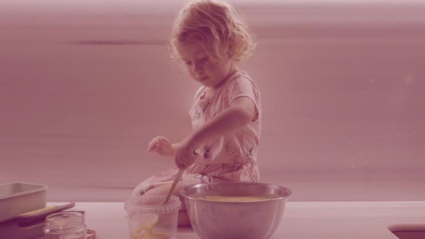 Child mixing ingredients in large bowl on counter — Stock Video