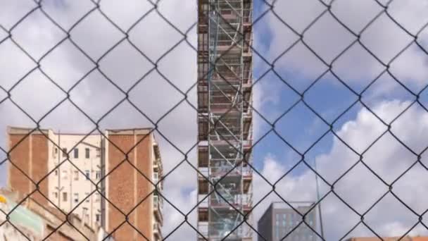 Sitio de construcción con nubes detrás de valla de alambre — Vídeos de Stock