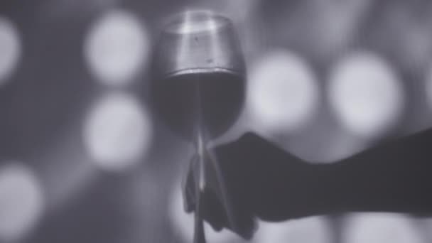 Shadow of hand holding a wine glasse — Stock Video