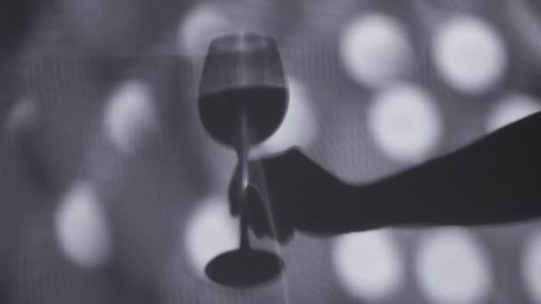 Shadow of hand holding a wine glasse — Stock Video