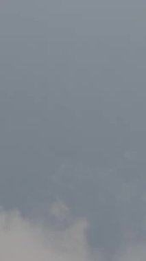 Günbatımında dikey olarak süper yavaş çekimde havalimanına iniş yapmak için üzerimizden uçan uçak