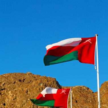 Umman dalgalanan bayrak ve bulutlu gökyüzü dağ