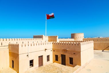 in oman    muscat    the   old defensive  fort battlesment sky a clipart