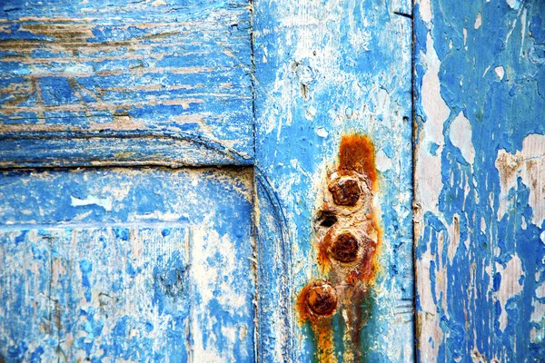 Paint in the blue wood door rusty nail — Stock Photo, Image