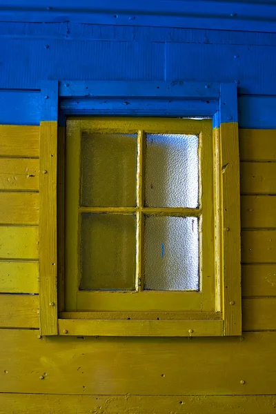 Old yellow window in blue wall — Stock Photo, Image