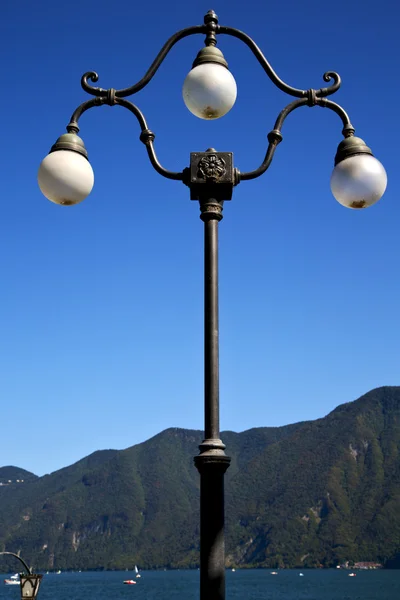 Street lamp a bulb in the   sky lake of lugano Switzerland — Stock Photo, Image