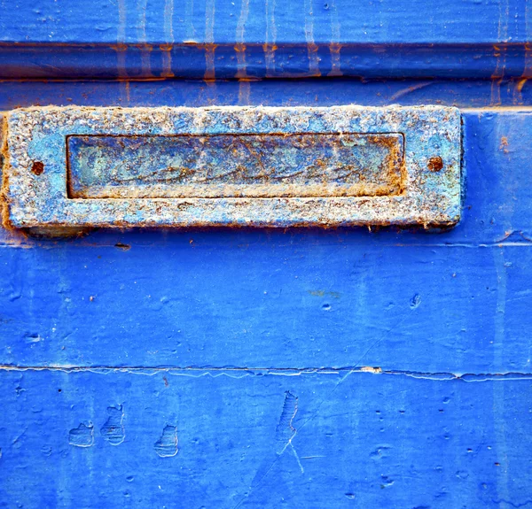 Tinta descascada suja na porta de madeira azul e unha enferrujada — Fotografia de Stock