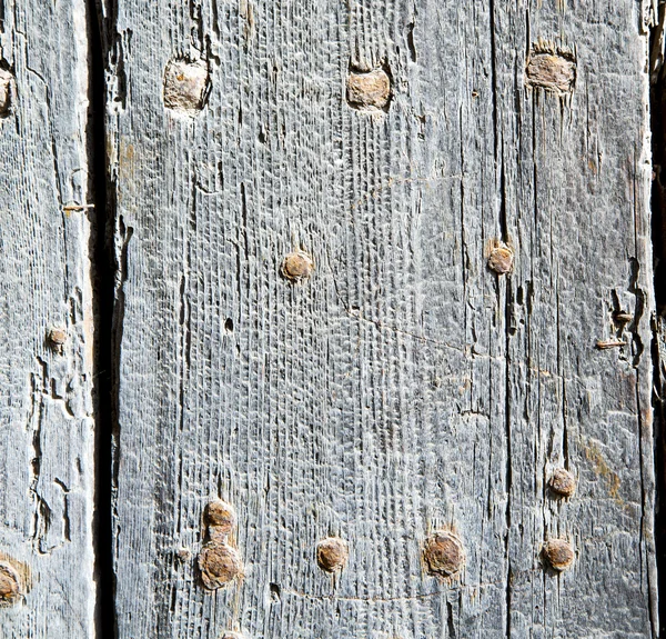 Chiodo di metallo sporco vernice spogliata nella porta di legno rosso marrone e — Foto Stock