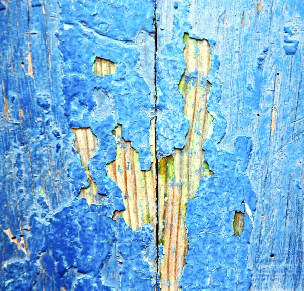 Stripped paint in the blue wood door and rusty nail — Stock Photo, Image