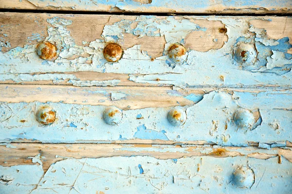 Dirty stripped paint in  blue wood door   rusty nail — Stock Photo, Image