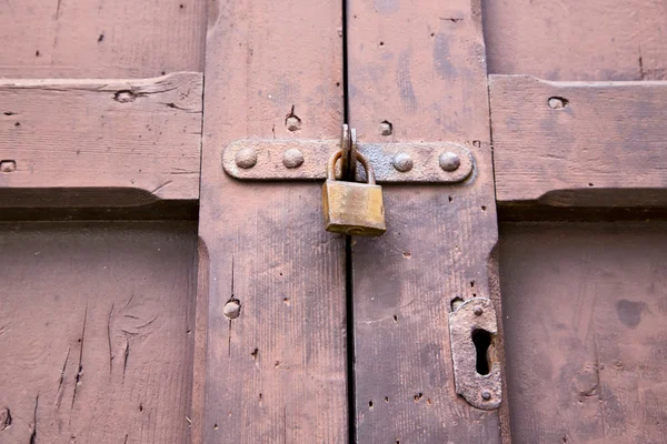 Abstrakta hänglås rostig knocker i en sluten trä dörr galla — Stockfoto