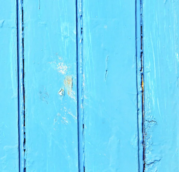 Stripped paint in the blue wood door and rusty nail — Stock Photo, Image