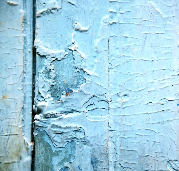 Dirty stripped paint in the blue wood door and rusty nail — Stock Photo, Image