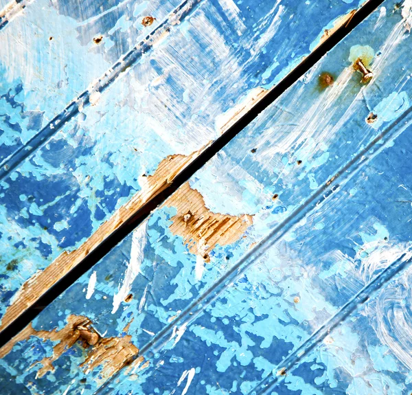 Stripped paint in the blue wood door and rusty nail — Stock Photo, Image