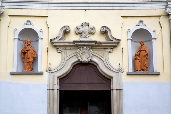 Dveře kostela v Itálii Lombardie štítu socha — Stock fotografie