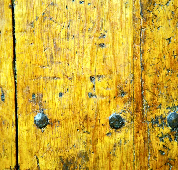 Metal nail dirty stripped paint in the brown   red wood door and — Stock Photo, Image