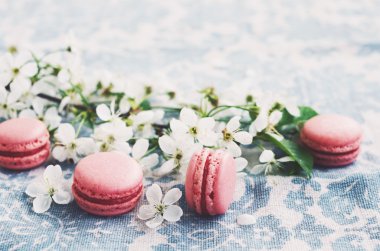 Pembe macaroons ve vintage masa örtüsü çiçeklenme kiraz çiçekleri