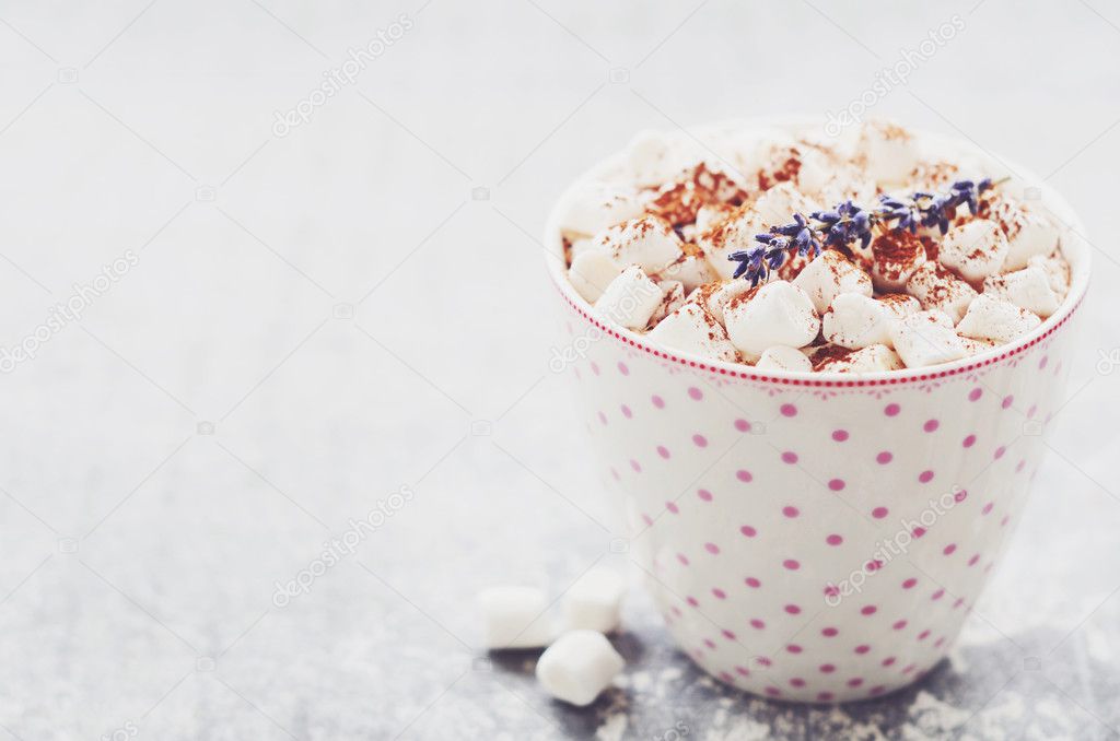 Marshmallow hot drink decorated with lavender flowers, copy space on grey background