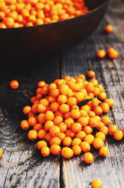 Bio-Sanddornbeeren auf rustikalem Holzgrund — Stockfoto