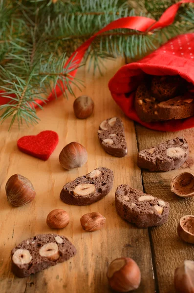 Decorazione natalizia con biscotti al cioccolato, nocciole e pino — Foto Stock