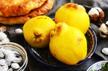 Quinces, flatbread and salty apricot pits in oriental way clipart