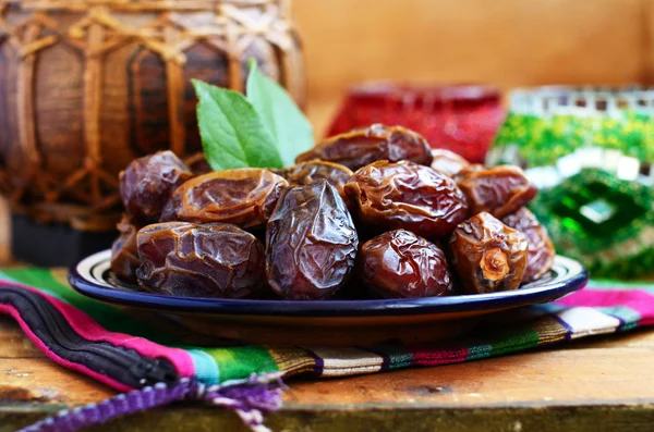 Dry dates on oriental ceramic plate with empty space — Stock Photo, Image