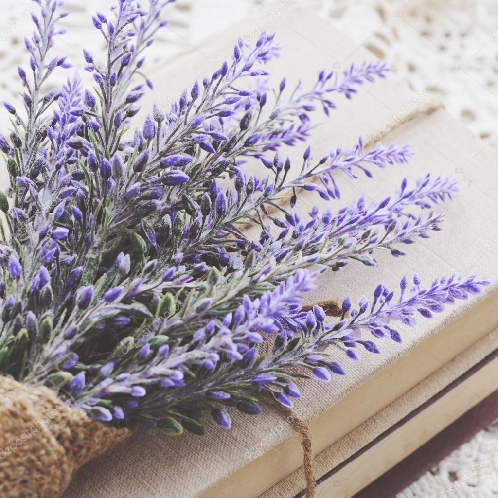 Decoration with lavender bunch upon vintage books bundle