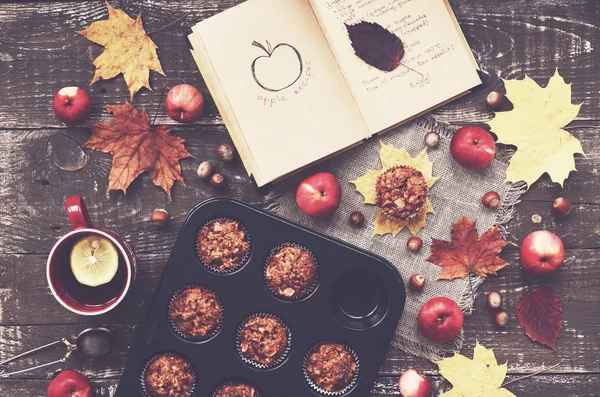 Homemade apple muffins and cup of tea with lemon, autumn mood