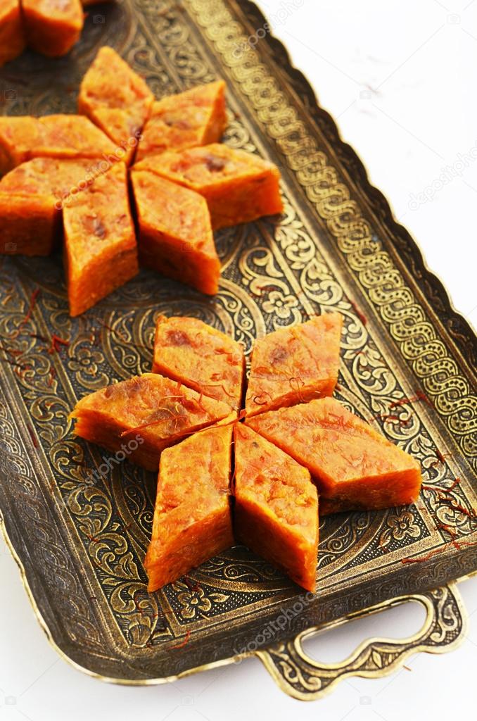 Homemade carrot halwa, traditional indian sweet, on brass tray