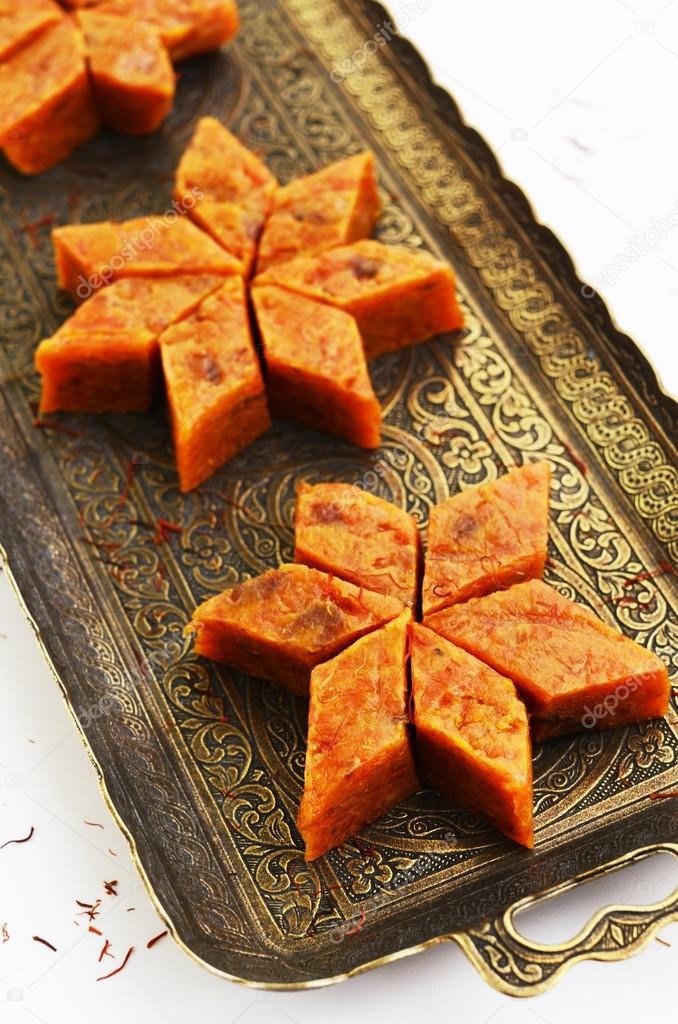 Homemade carrot halwa, traditional indian dessert, on brass tray