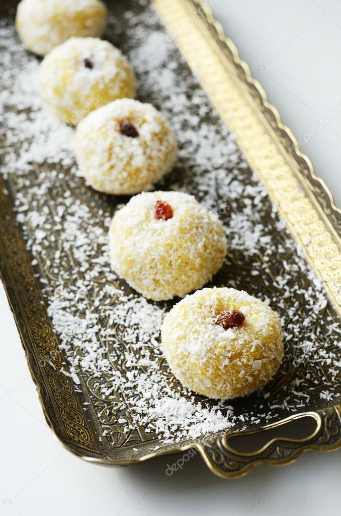 Homemade ladoo - traditional indian sweets on brass tray