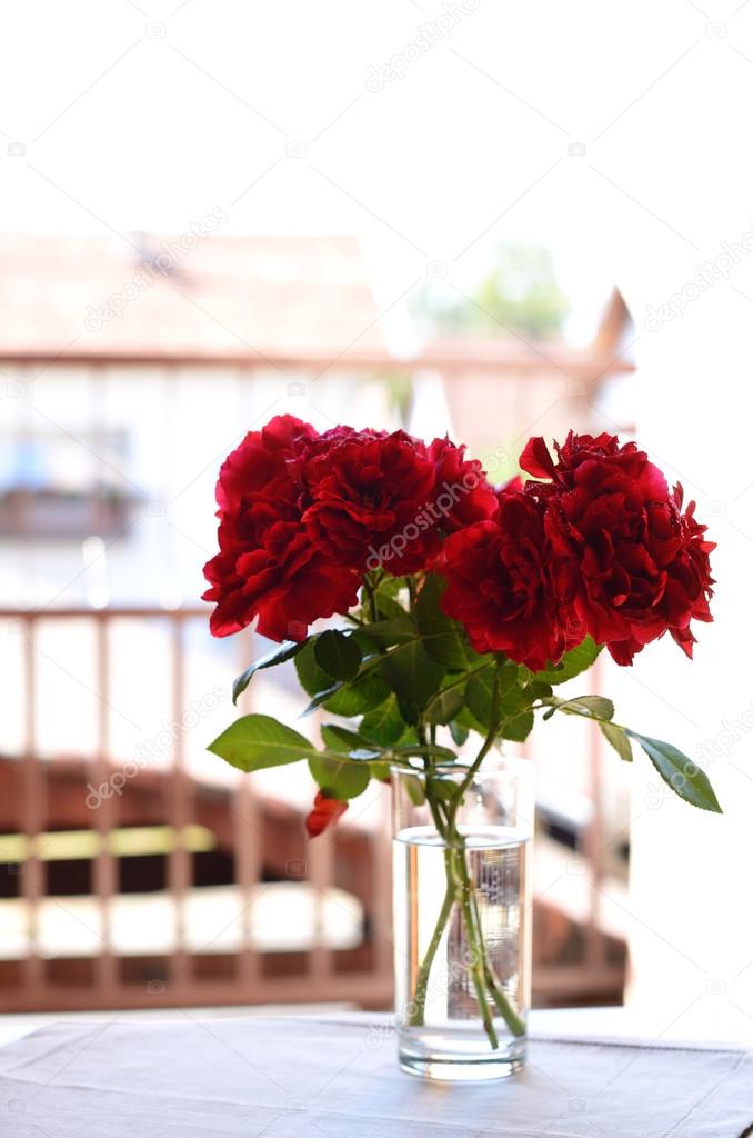 Bunch of wine red roses on the balcony