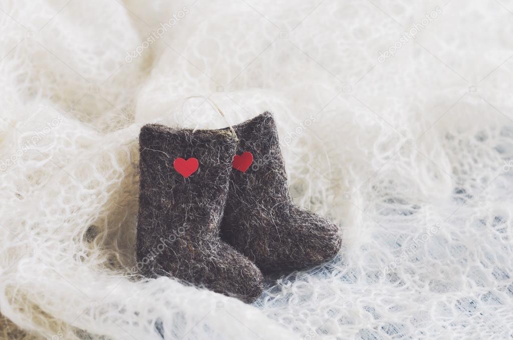Tiny felted valenki with hearts on knitted downy shawl