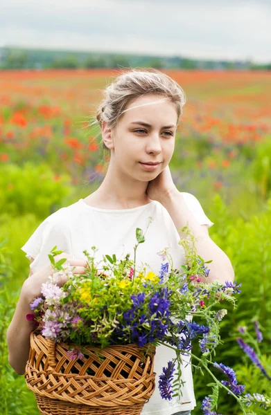 Vacker blond flicka med blommor — Stockfoto