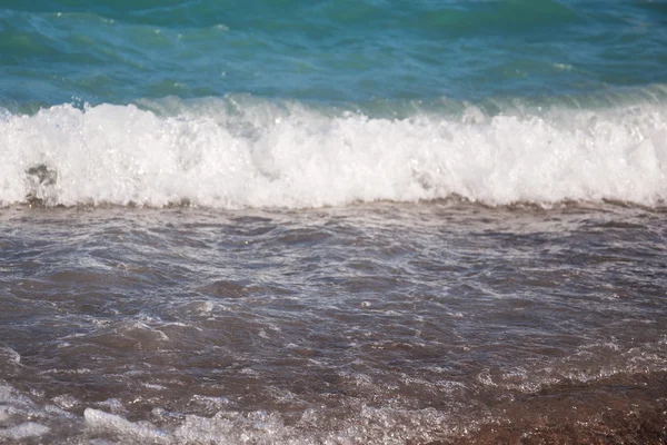 Stones on beach and sea water — Stock Photo, Image